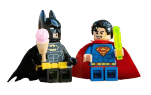 Toy figures batman and superman enjoying an ice-cream together